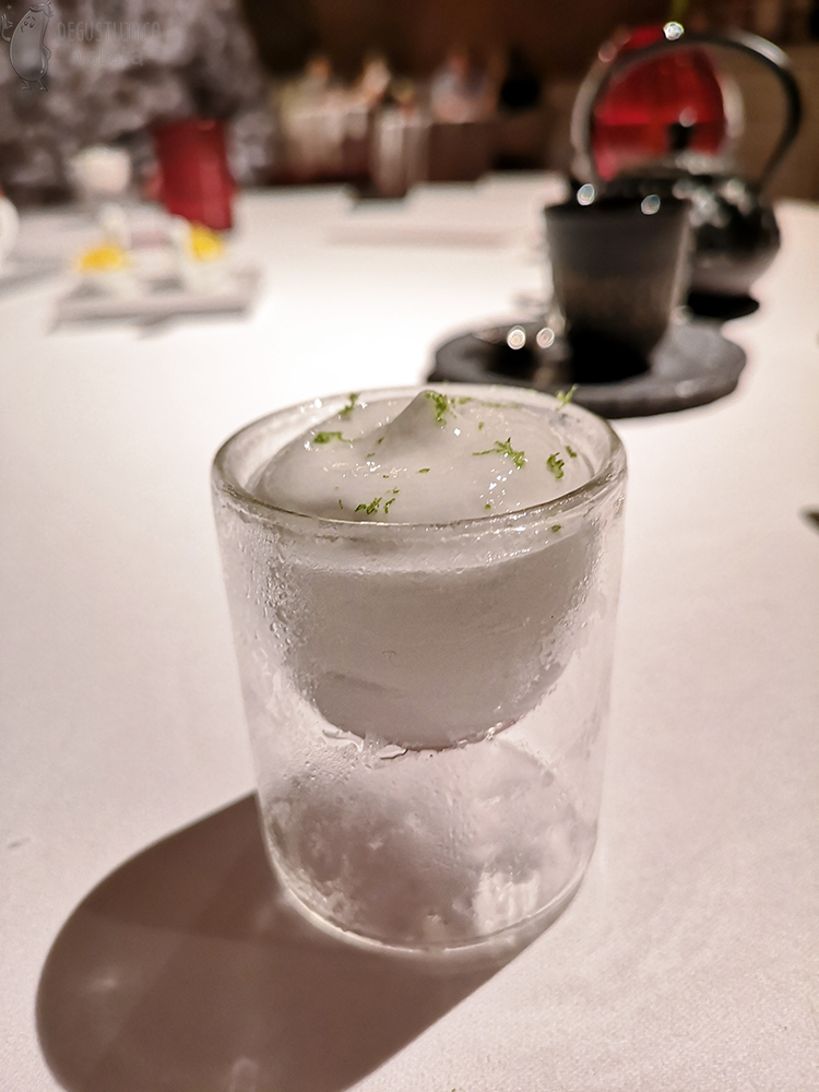 A small glass filled with white cream. 