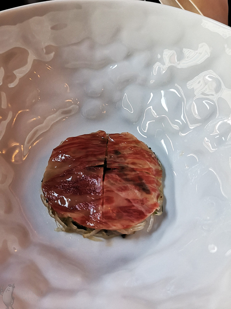 Round wagyu slice on pickled turnip before pouring over broth.