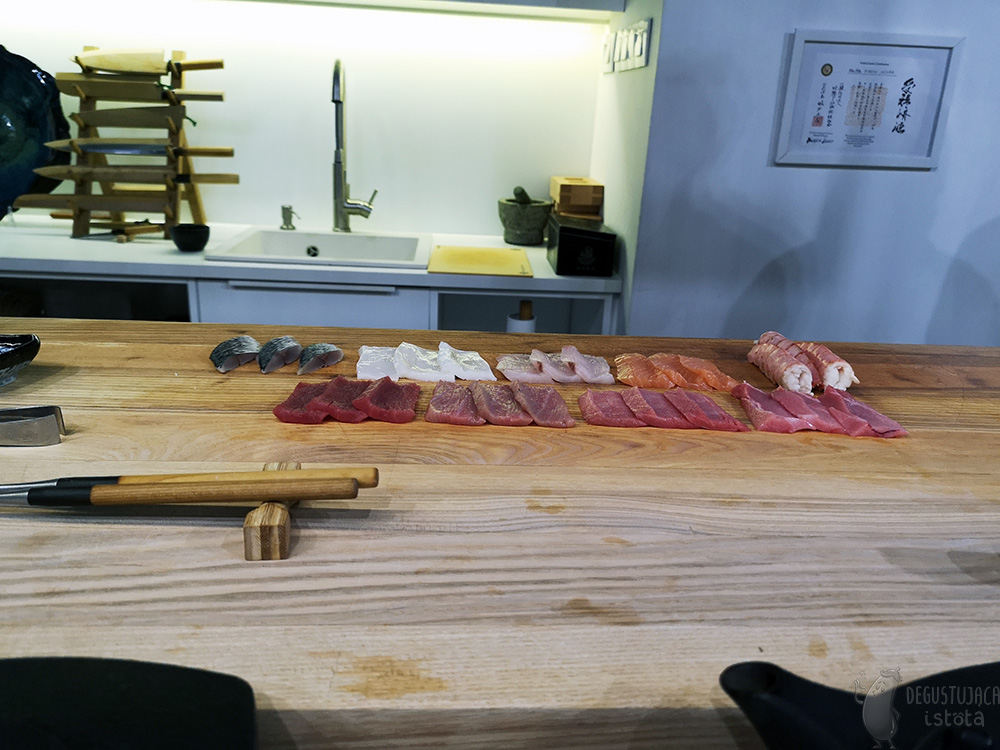 On a large board are prepared 3 pieces of each type of fish or seafood.