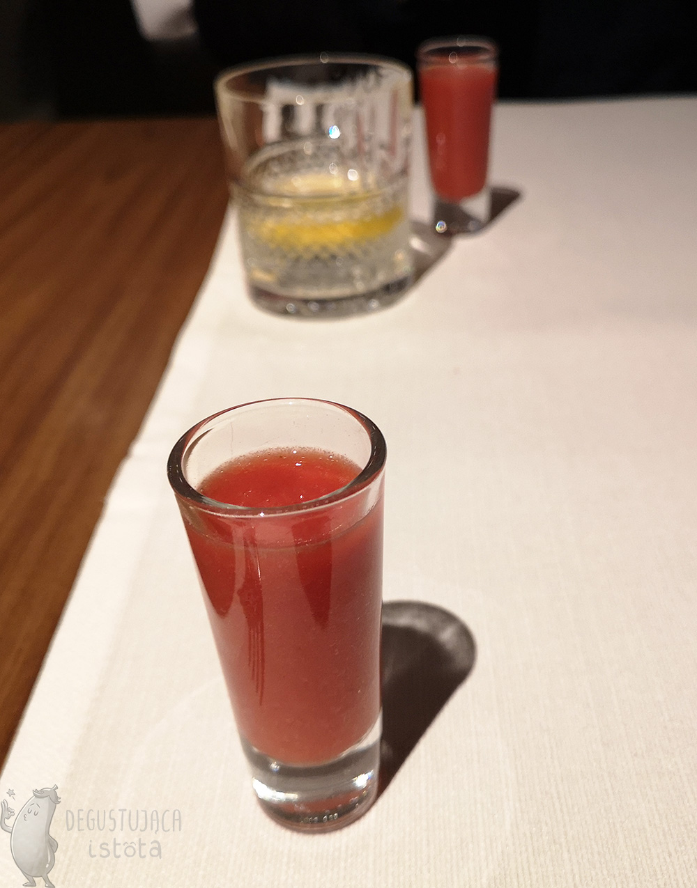 A glass with thick red liquid.